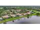 Scenic aerial view of homes nestled among lush greenery and a sparkling lake at 7214 Marlow Pl, University Park, FL 34201