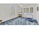 Bright bedroom featuring a window with plantation shutters, blue carpet and a ceiling fan at 7214 Marlow Pl, University Park, FL 34201