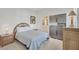 Cozy bedroom with neutral tones, wicker accents, and ensuite bathroom creating a calming retreat at 7214 Marlow Pl, University Park, FL 34201