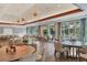 Bright dining room with herringbone floors, chandeliers, and large windows offering outdoor views at 7214 Marlow Pl, University Park, FL 34201