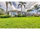 Lovely exterior view of the home featuring a screened-in pool and lush landscaping at 7214 Marlow Pl, University Park, FL 34201