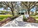 Community tennis and fitness center in landscaped setting with mature shade trees and well maintained lawn at 7214 Marlow Pl, University Park, FL 34201