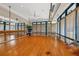 Bright fitness studio with wood floor, mirrored wall, barre, and many windows with blinds at 7214 Marlow Pl, University Park, FL 34201