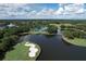 Breathtaking aerial shot of golf course, lake, and lush landscaping on a sunny day at 7214 Marlow Pl, University Park, FL 34201