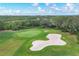 Beautiful golf course view with lush green grass and a sand trap on a sunny day at 7214 Marlow Pl, University Park, FL 34201