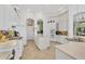 Bright kitchen with white cabinetry, a center island, and colorful backsplash adds unique design at 7214 Marlow Pl, University Park, FL 34201