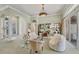 Bright living room with a glass table, comfortable seating, display cases, and an arched doorway for added elegance at 7214 Marlow Pl, University Park, FL 34201