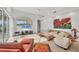 Bright living room featuring a large painting, comfortable furniture, and lots of natural light at 7214 Marlow Pl, University Park, FL 34201