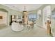 Elegant living room featuring neutral tones, plush seating, and arched doorways with a view of the outdoor living area at 7214 Marlow Pl, University Park, FL 34201