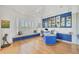 Bright office with custom blue cabinetry, window seat, and stylish wood floors, ideal for productivity at 7214 Marlow Pl, University Park, FL 34201