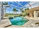 Gorgeous screened-in pool and lanai with lush tropical landscaping and tranquil lake views at 7214 Marlow Pl, University Park, FL 34201