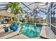Beautiful screened-in pool and lanai area with a jacuzzi and lush landscaping at 7214 Marlow Pl, University Park, FL 34201