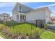 Charming fenced backyard features manicured lawn and professional landscaping, creating a private outdoor oasis at 7279 Kodiak Ln, Sarasota, FL 34240