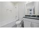 Clean and modern bathroom with white tile, a shower-tub combo, and a sleek vanity at 7279 Kodiak Ln, Sarasota, FL 34240