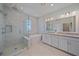 Luxurious bathroom with a walk-in shower, soaking tub, double vanity, and sleek fixtures at 7279 Kodiak Ln, Sarasota, FL 34240