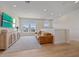 Bright bonus room with comfortable seating, decorative console, and views from multiple windows at 7279 Kodiak Ln, Sarasota, FL 34240
