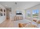 Bright bonus room with comfortable seating, decorative console, and views from multiple windows at 7279 Kodiak Ln, Sarasota, FL 34240