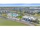 Picturesque aerial view of community pool featuring palm trees and luxurious poolside lounge area, waterfront views at 7279 Kodiak Ln, Sarasota, FL 34240