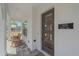 View of front entrance with rocking chairs, modern door with windows and address at 7279 Kodiak Ln, Sarasota, FL 34240