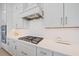 Well-lit kitchen with a gas range, modern white cabinets, quartz countertops, and stainless steel appliances at 7279 Kodiak Ln, Sarasota, FL 34240