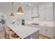 Modern kitchen features a large island, stainless steel appliances, and pendant lighting at 7279 Kodiak Ln, Sarasota, FL 34240