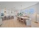 Open-concept kitchen and dining area with stainless steel appliances, breakfast bar, and modern pendant lighting at 7279 Kodiak Ln, Sarasota, FL 34240