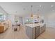 Open floor plan with kitchen island, stainless steel appliances, and view to dining and living area at 7279 Kodiak Ln, Sarasota, FL 34240
