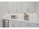 Kitchen counter with stainless steel toaster oven, espresso maker, wine cooler, and white cabinets at 7279 Kodiak Ln, Sarasota, FL 34240