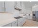Bright kitchen with white cabinetry, stainless steel appliances, quartz countertops, and a gas range at 7279 Kodiak Ln, Sarasota, FL 34240