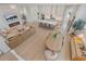 Aerial view of open-concept living space featuring kitchen, dining, and living room with modern decor at 7279 Kodiak Ln, Sarasota, FL 34240