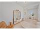 Spacious living room featuring hardwood floors, large mirror, and stylish furnishings at 7279 Kodiak Ln, Sarasota, FL 34240