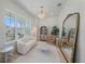 Bright living room with a white sofa, stylish decor, and large windows offering natural light at 7279 Kodiak Ln, Sarasota, FL 34240