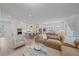 Open-concept living space with kitchen island, stainless appliances, and comfortable living room seating at 7279 Kodiak Ln, Sarasota, FL 34240