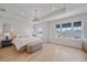 Airy main bedroom with tray ceiling, ample natural light, and contemporary chandelier at 7279 Kodiak Ln, Sarasota, FL 34240