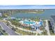 Aerial view of a community pool area surrounded by palm trees, lounge chairs, and resort-style amenities at 7279 Kodiak Ln, Sarasota, FL 34240