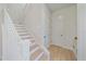 Bright staircase with hardwood steps and white railings, leading to the upper level of the home at 7279 Kodiak Ln, Sarasota, FL 34240