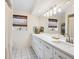 A renovated bathroom with double sinks, updated lighting, and modern fixtures at 7460 Dickens Dr, Sarasota, FL 34231