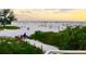 Lush landscaping and scenic view of a popular beach featuring beach volleyball and calm ocean waters at 7460 Dickens Dr, Sarasota, FL 34231
