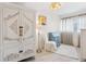 A neutral room with detailed armoire, a decorative chandelier, and updated window treatments at 7460 Dickens Dr, Sarasota, FL 34231