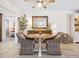Cozy dining area featuring a round table, wicker chairs, and charming decor, perfect for intimate meals at 7460 Dickens Dr, Sarasota, FL 34231