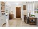 Bright foyer featuring a tiled floor, wooden door, and stylish decor accents at 7460 Dickens Dr, Sarasota, FL 34231