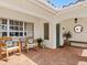 Inviting front porch featuring decorative chairs and a brick-paved entryway at 7460 Dickens Dr, Sarasota, FL 34231