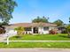 Inviting home with a well-manicured lawn, flowering plants and charming curb appeal at 7460 Dickens Dr, Sarasota, FL 34231