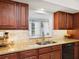 Close-up of kitchen area showcasing granite countertops, modern sink, and wood cabinetry at 7460 Dickens Dr, Sarasota, FL 34231