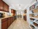 Open-concept kitchen with stainless steel appliances, granite countertops, dark wood cabinetry, tile floor and ample storage at 7460 Dickens Dr, Sarasota, FL 34231