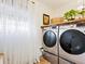 A functional laundry room featuring modern appliances and additional storage at 7460 Dickens Dr, Sarasota, FL 34231