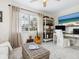 An office space is accentuated with a TV, guitar, woven coffee table, and updated shelving at 7460 Dickens Dr, Sarasota, FL 34231