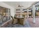 Inviting covered patio with ceiling fan, brick pavers, dining table, and view of the fenced yard at 7460 Dickens Dr, Sarasota, FL 34231