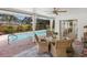 A covered patio features a dining area, pool view, and decorative accents at 7460 Dickens Dr, Sarasota, FL 34231
