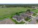 Aerial shot showcasing the neighborhood homes with green lawns and serene water views at 7744 Castleisland Dr, Sarasota, FL 34240